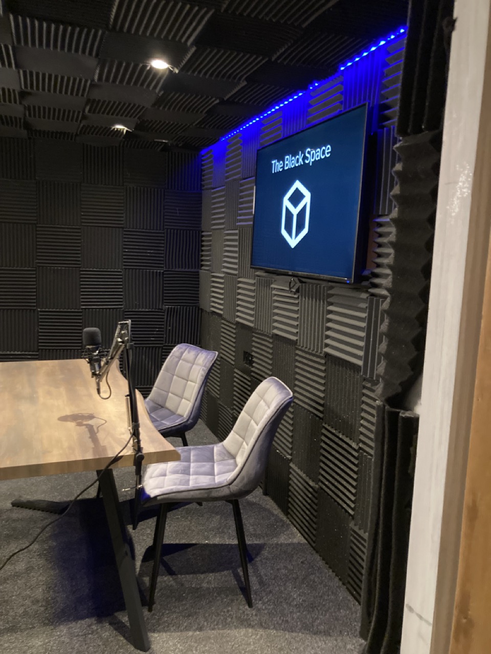 The Black Space The Black Space with table, chairs, microphone and LED screen